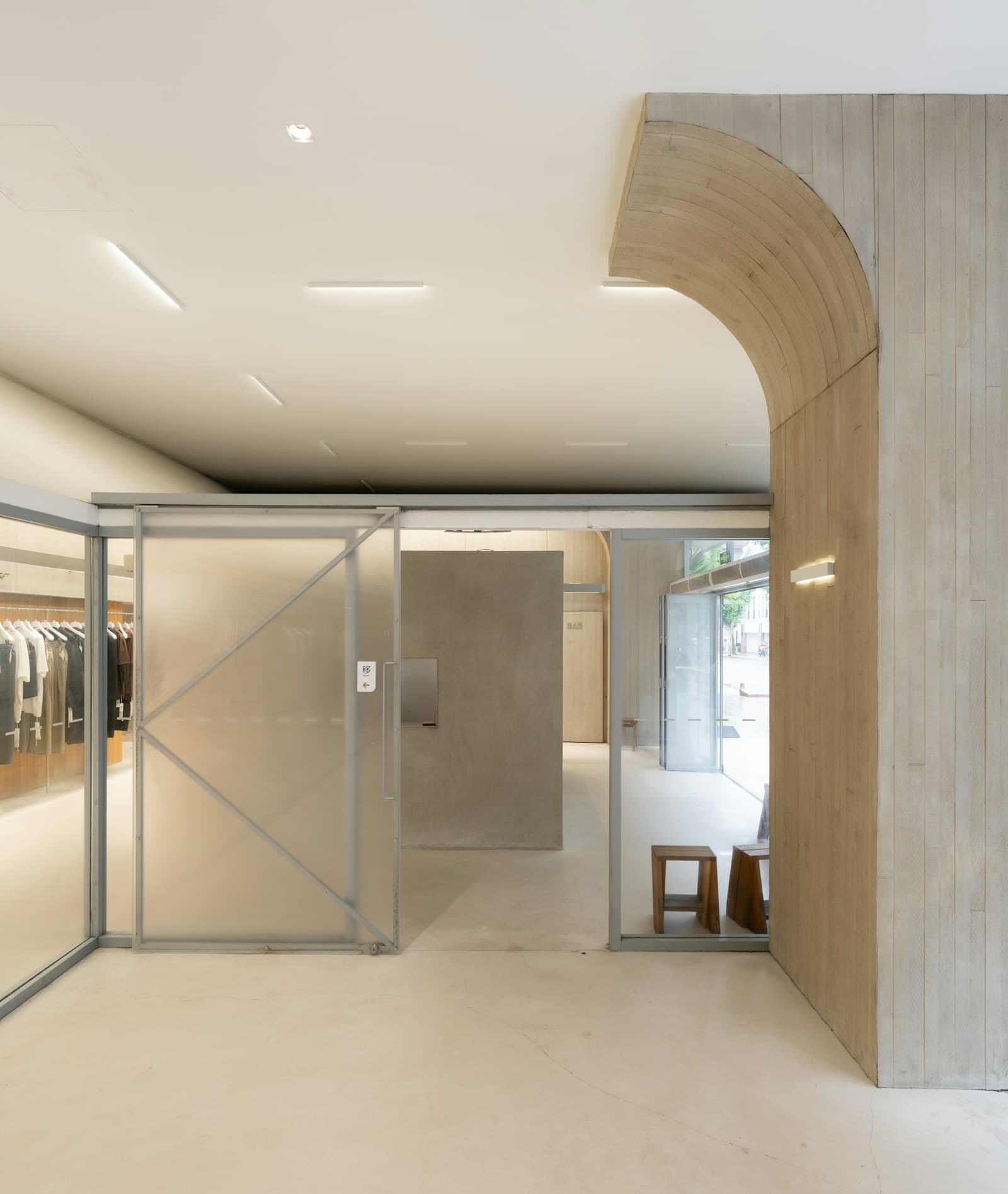 Modern retail interior with a concrete arch and glass partitions